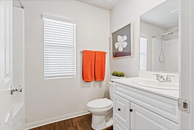 a bathroom with a toilet a sink and a window