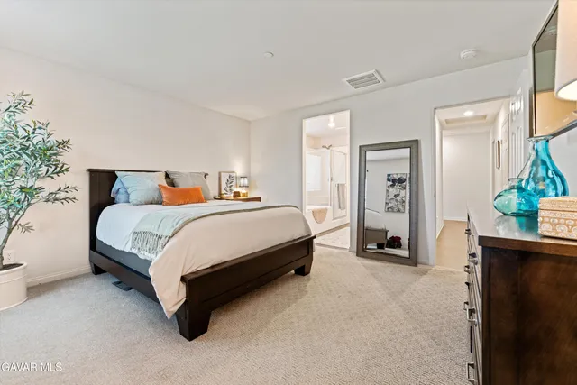 a bedroom with a bed and a dresser