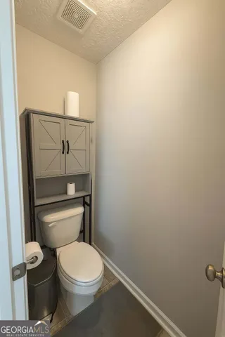 a white toilet sitting next to a shower