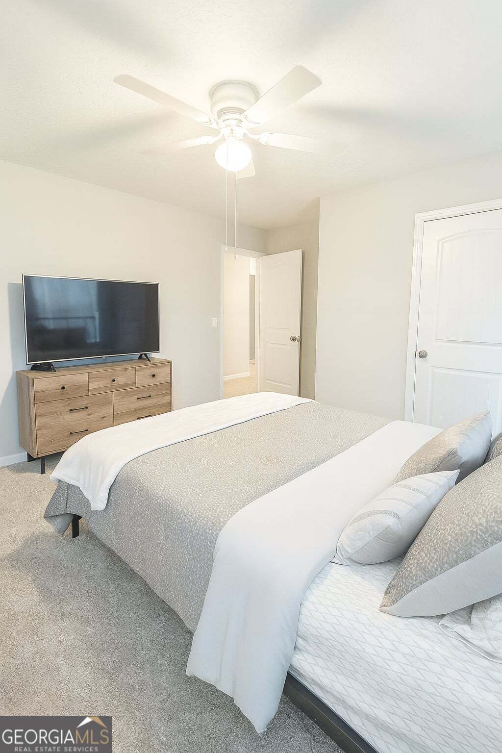 1343 Talmadge Road Allenhurst, GA 31301 - Photo 14 of 17 a bedroom with a large bed and a flat tv screen on a dresser