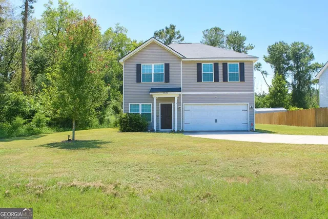 a front view of a house with a yard