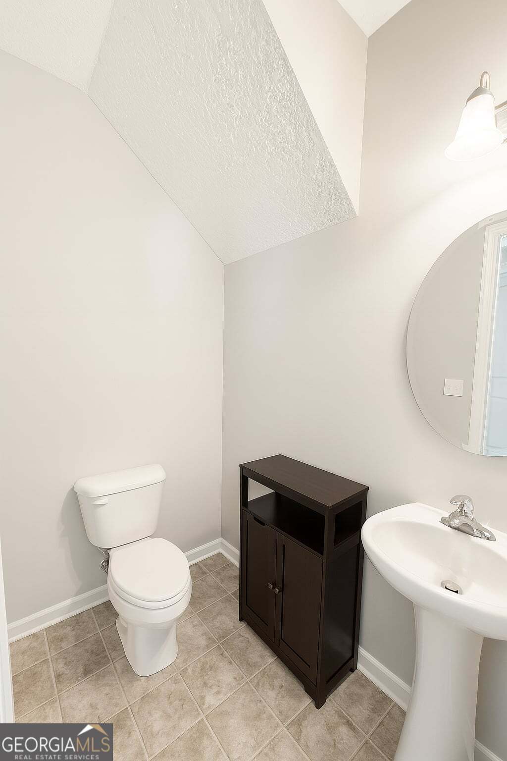 1343 Talmadge Road Allenhurst, GA 31301 - Photo 7 of 17 a bathroom with a toilet a sink and mirror