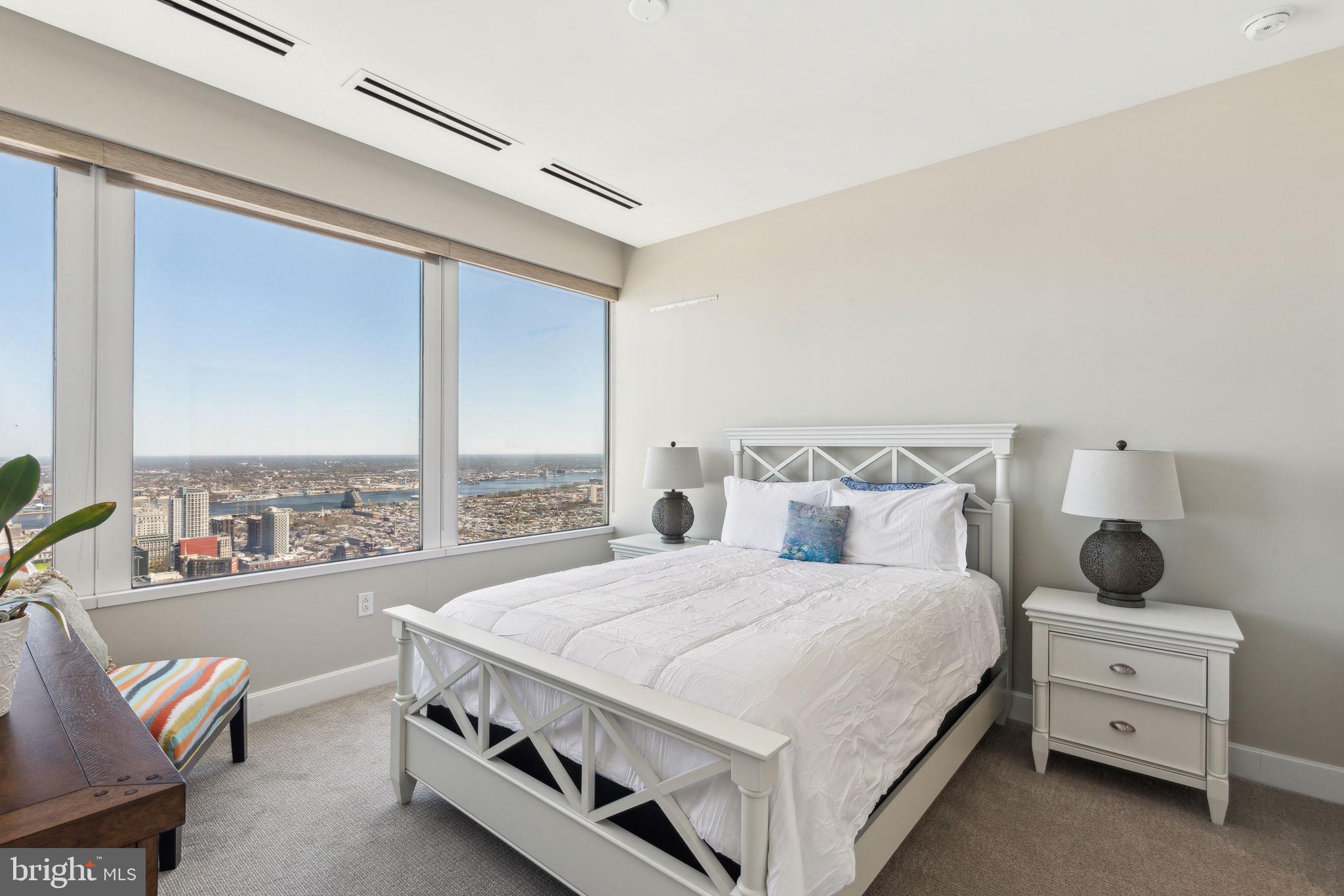 50 South 16th Street, Unit 5306 Philadelphia, PA 19103 - Photo 12 of 40 a bedroom with a bed and a large window