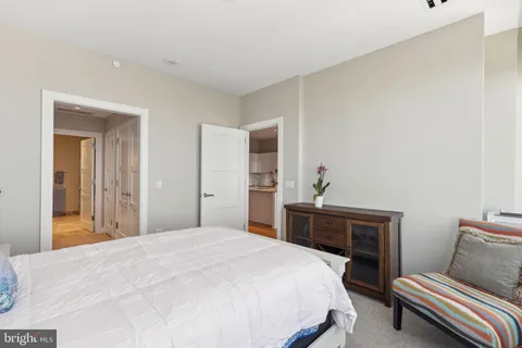 a bedroom with a bed and a dresser