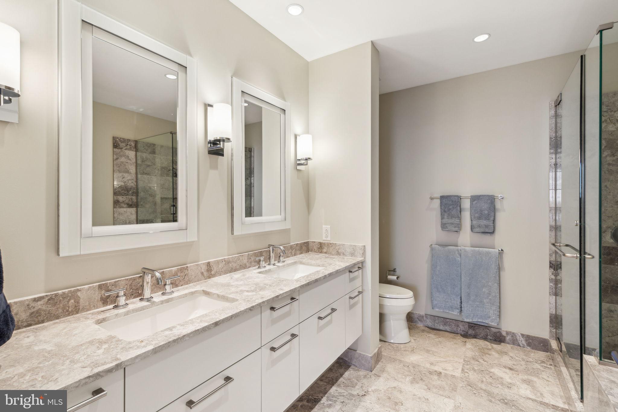 50 South 16th Street, Unit 5306 Philadelphia, PA 19103 - Photo 14 of 40 a bathroom with a granite countertop sink mirror and a toilet