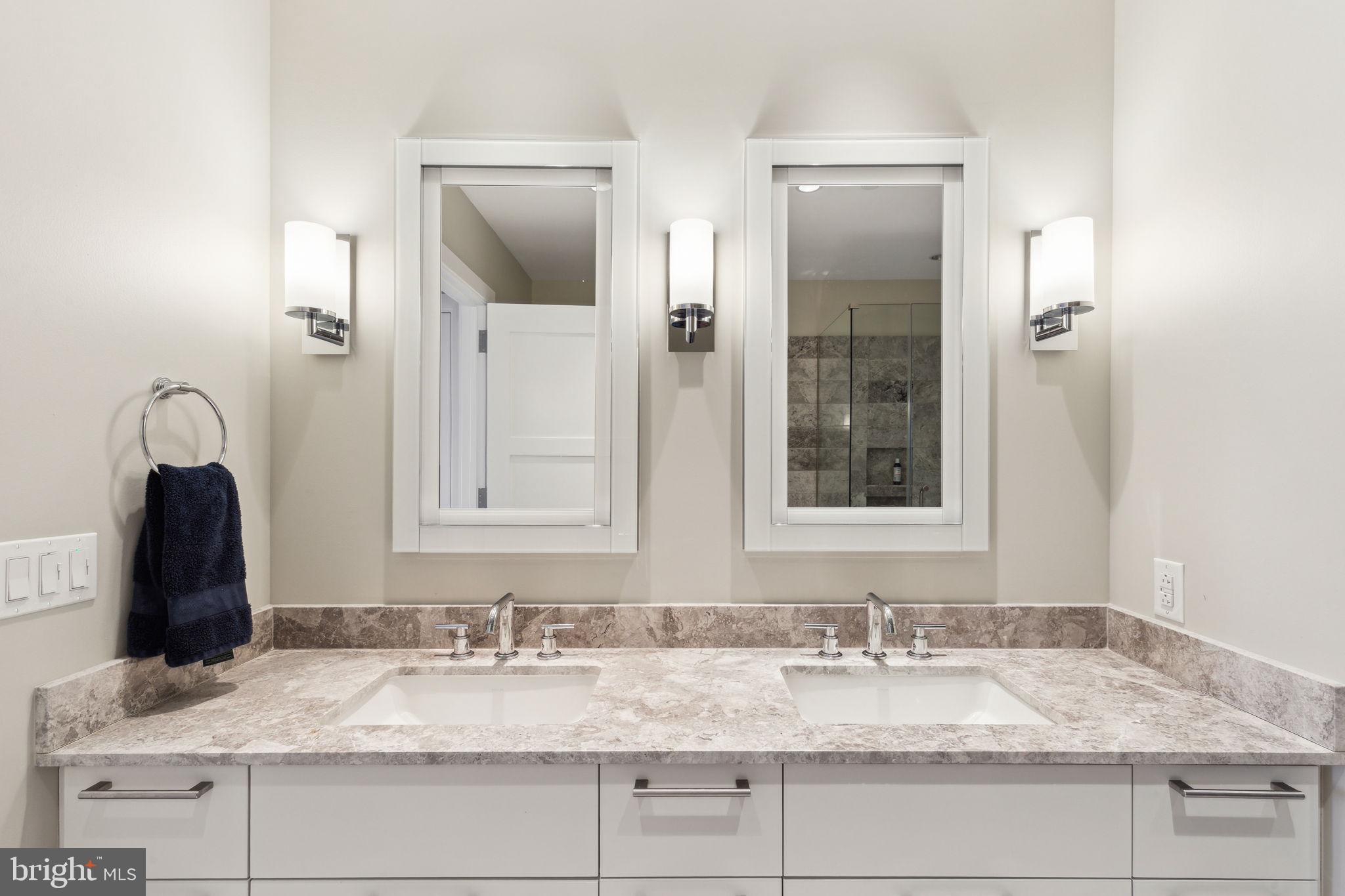 50 South 16th Street, Unit 5306 Philadelphia, PA 19103 - Photo 15 of 40 a bathroom with a granite countertop sink and a mirror