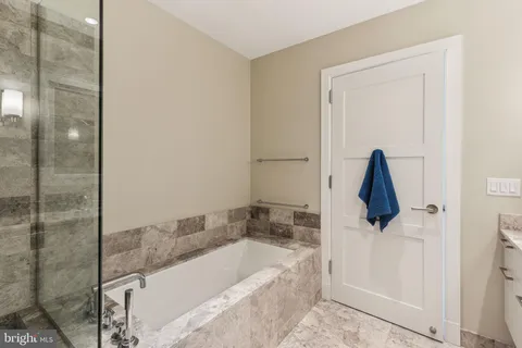 a bathroom with a tub and a shower