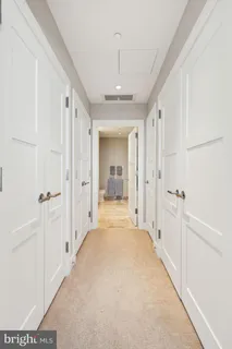 a view of a hallway with wooden shelves