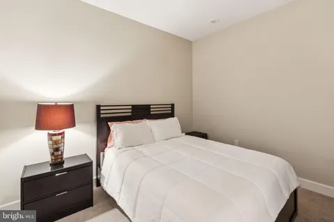 a bedroom with a bed and a lamp