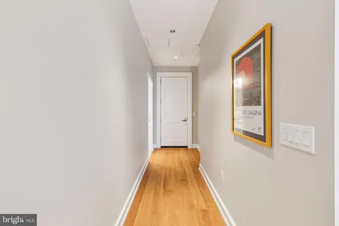 a view of a hallway with wooden floor