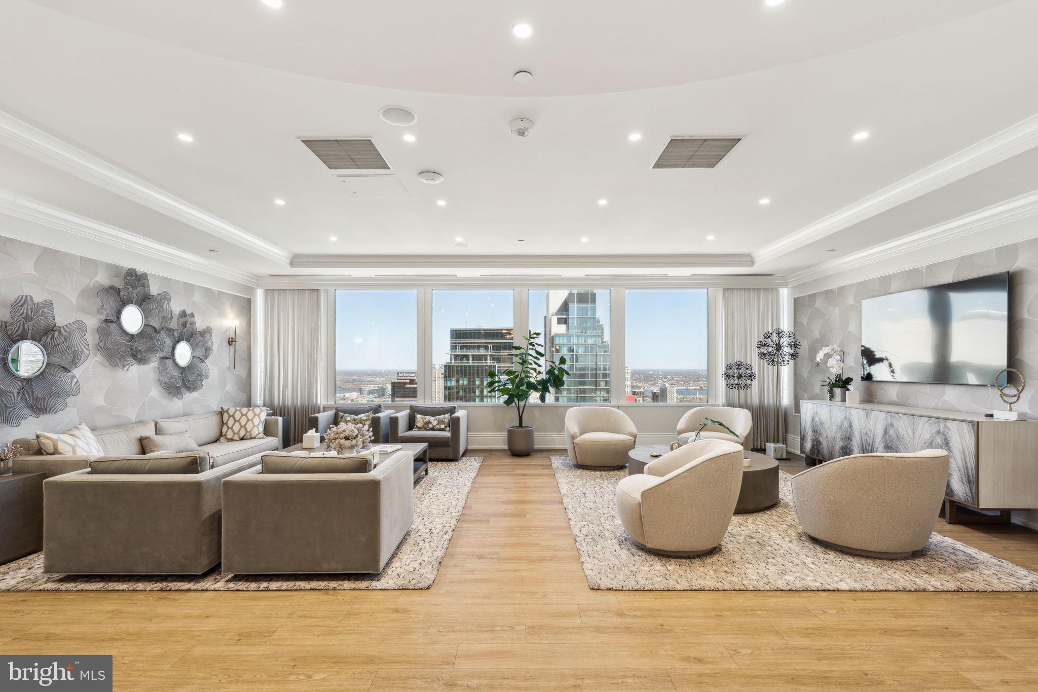 50 South 16th Street, Unit 5306 Philadelphia, PA 19103 - Photo 24 of 40 a living room with furniture kitchen view and large windows