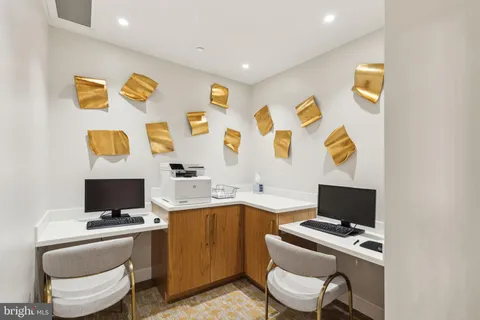 a workspace with furniture and screen