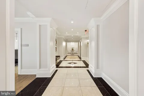 a view of a hallway with wooden floor and a large window