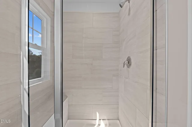 a bathroom with a glass shower door