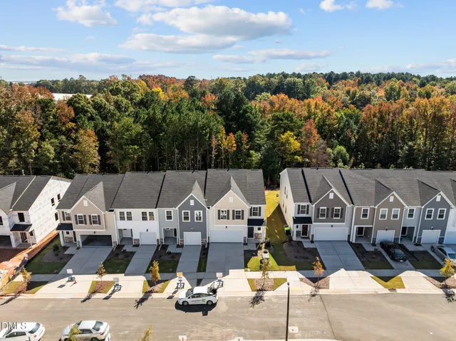 an aerial view of a house with swimming pool and mountain view