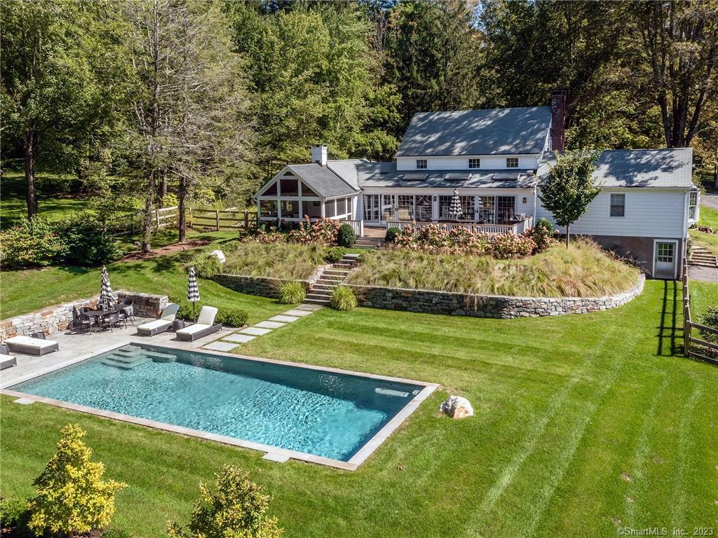 a front view of house with a garden and trees