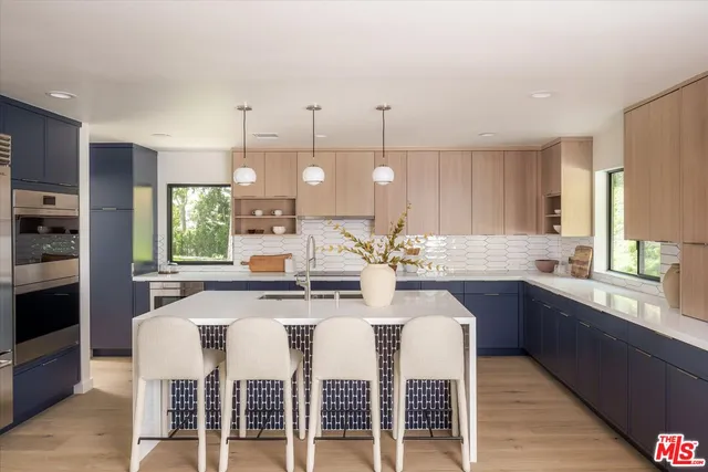 a large kitchen with a table and chairs