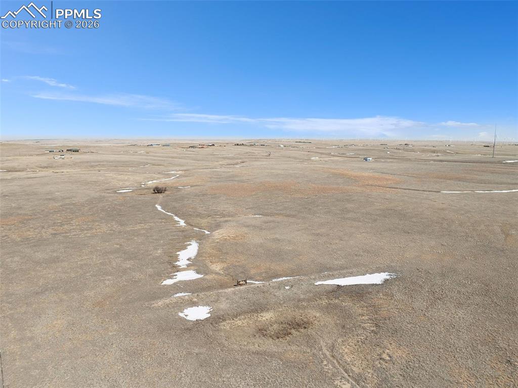 28350 Washington Road Calhan, CO 80808 - Photo 4 of 18 Ground-level view of the property looking across the open landscape.