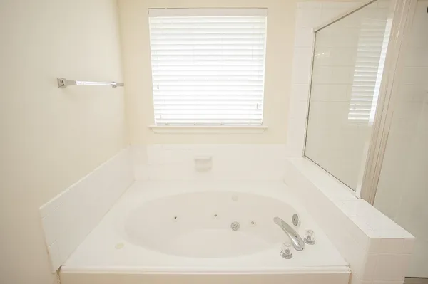 a white bath tub sitting next to a window