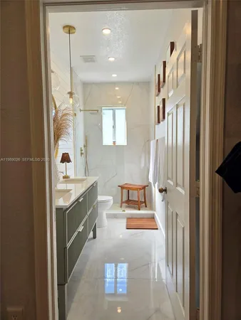 a bathroom with a bathtub sink and mirror