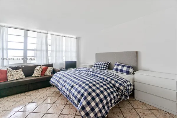a bedroom with a bed and with couch