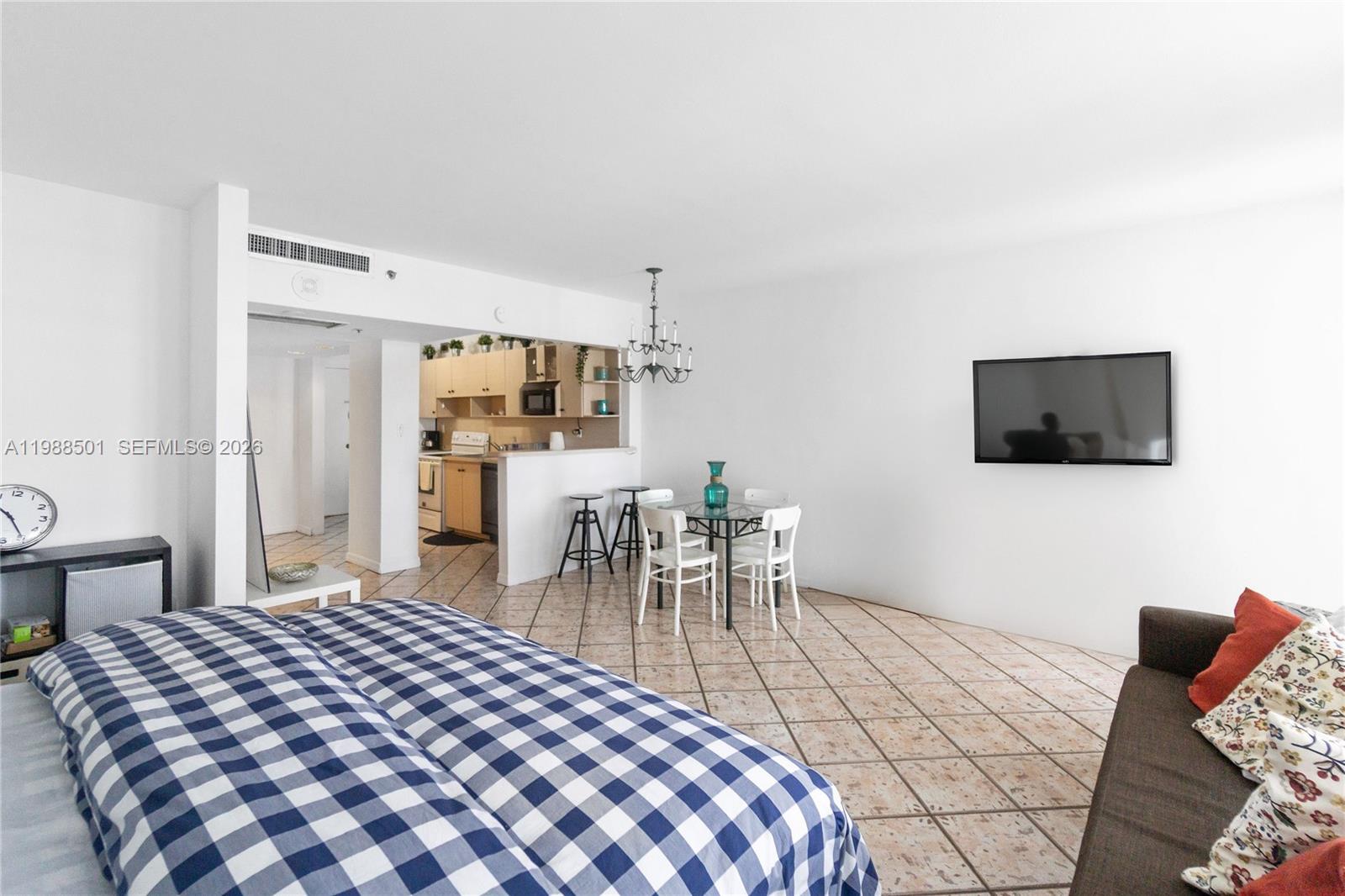 100 Lincoln Road, Unit 818 Miami Beach, FL 33139 - Photo 4 of 18 a bedroom with a bed and a television