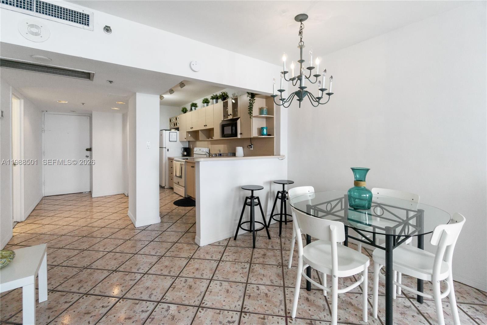 100 Lincoln Road, Unit 818 Miami Beach, FL 33139 - Photo 5 of 18 a view of a dining room with furniture and chandelier