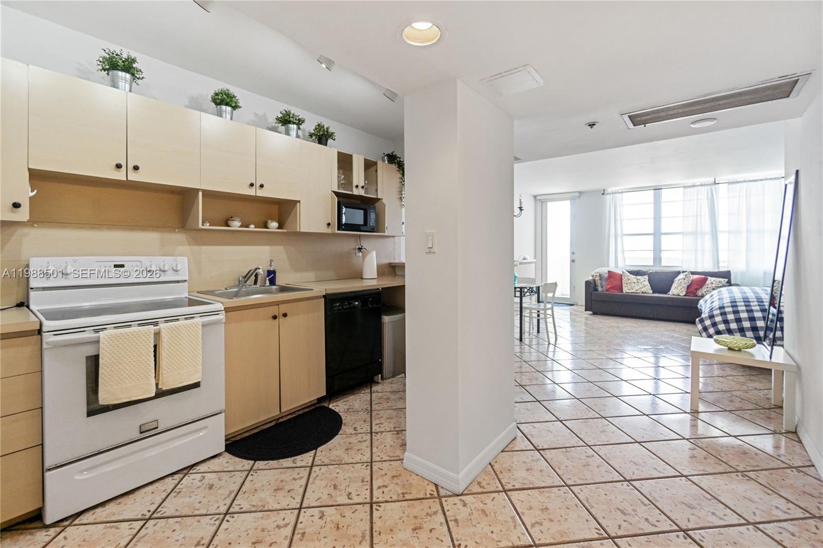 100 Lincoln Road, Unit 818 Miami Beach, FL 33139 - Photo 6 of 18 a kitchen with stainless steel appliances a stove refrigerator sink and cabinets