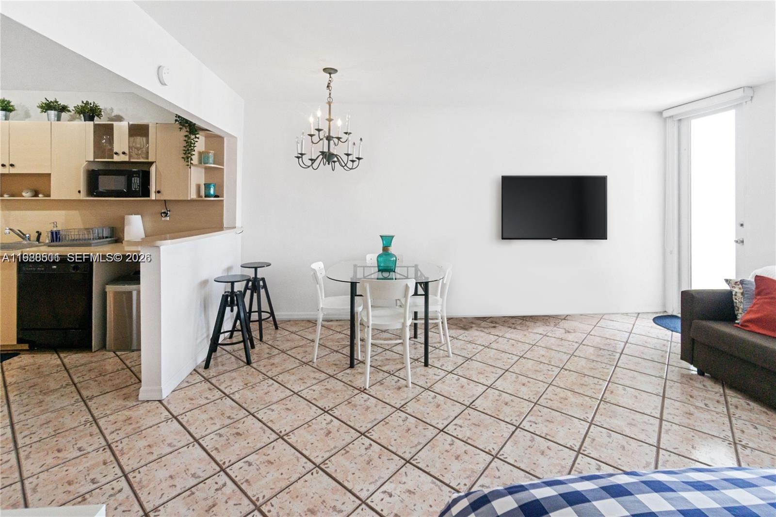 100 Lincoln Road, Unit 818 Miami Beach, FL 33139 - Photo 7 of 18 a living room with furniture and a flat screen tv