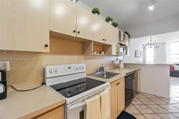 a kitchen with a sink a stove and cabinets