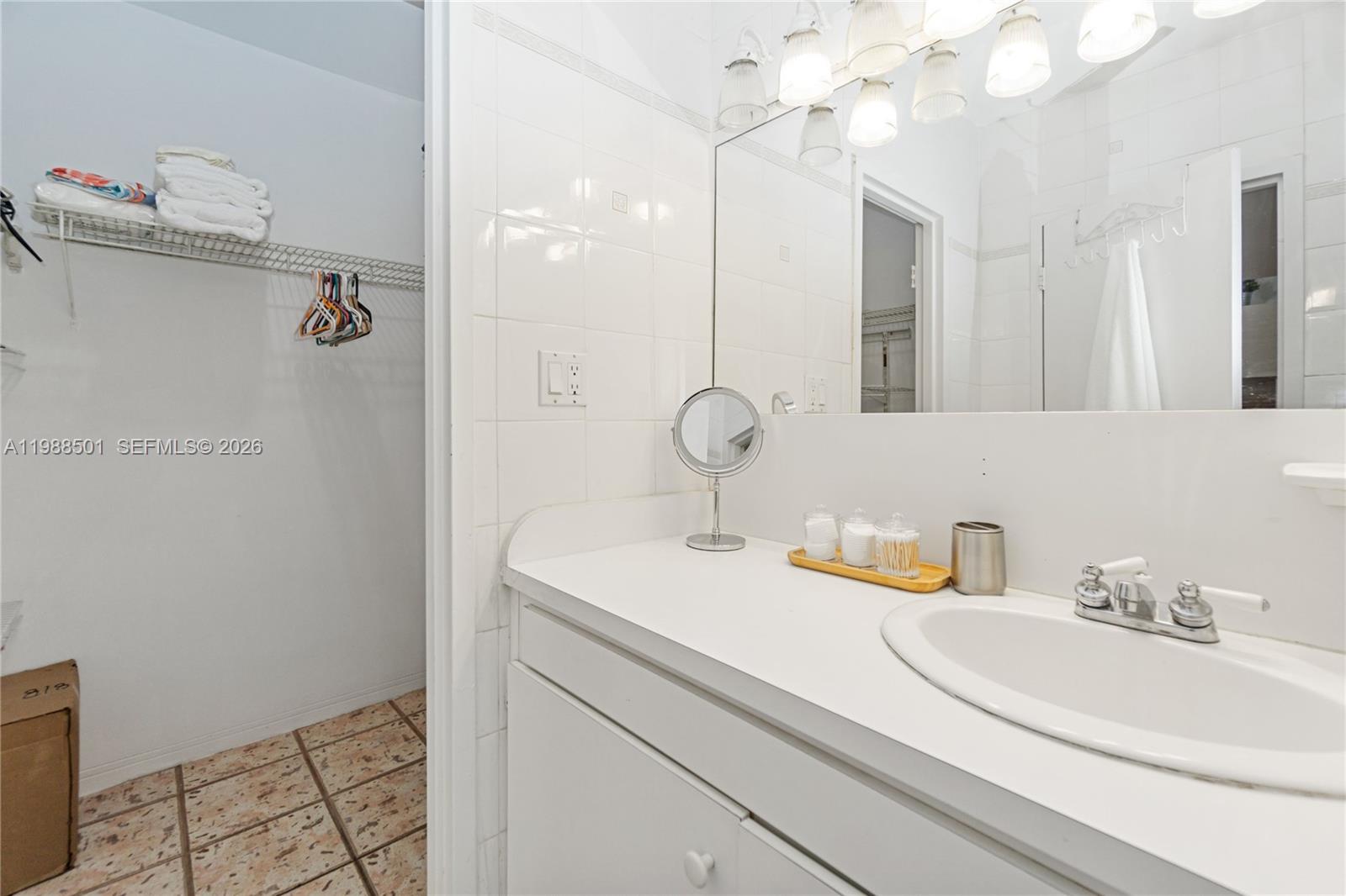 100 Lincoln Road, Unit 818 Miami Beach, FL 33139 - Photo 10 of 18 a bathroom with a sink and mirror