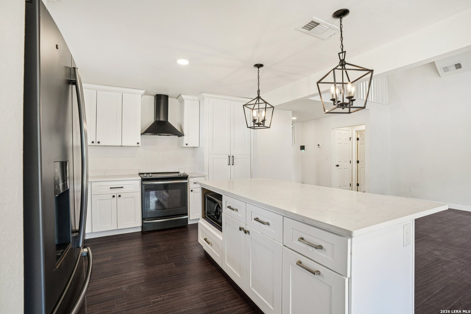 706 Quail Run Lytle, TX 78052 - Photo 17 of 51 a kitchen with white cabinets and stainless steel appliances