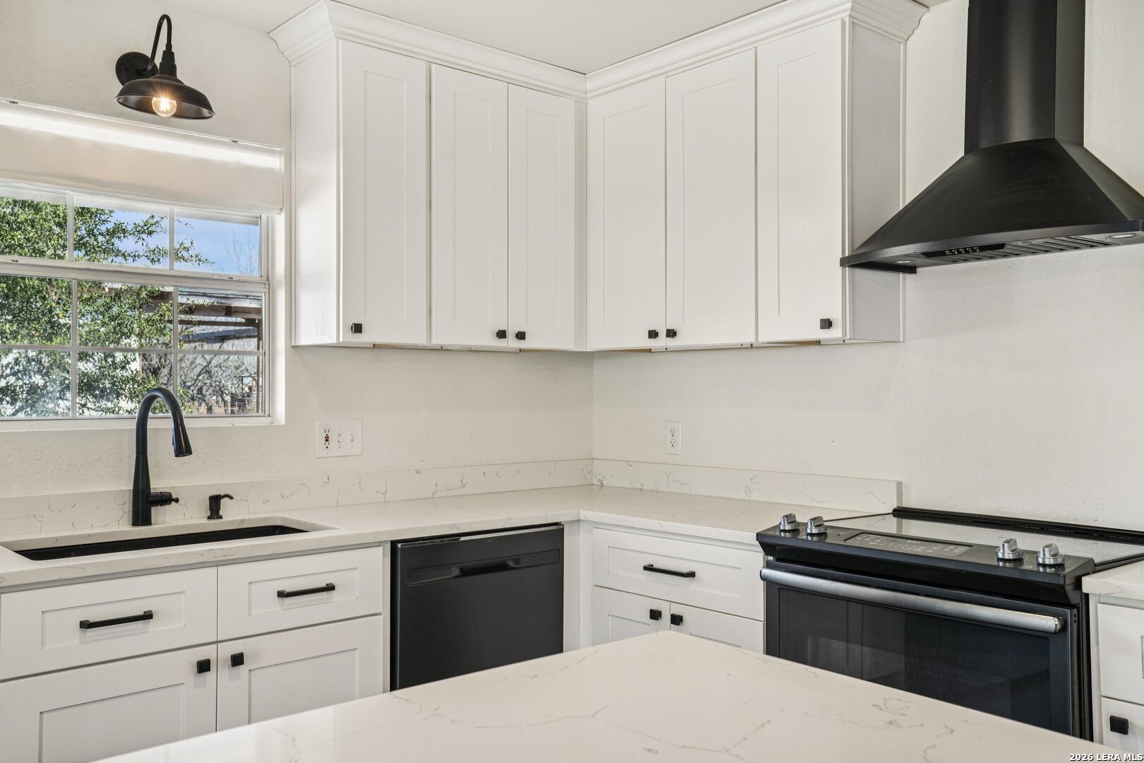 706 Quail Run Lytle, TX 78052 - Photo 19 of 51 a kitchen with a stove and white cabinets