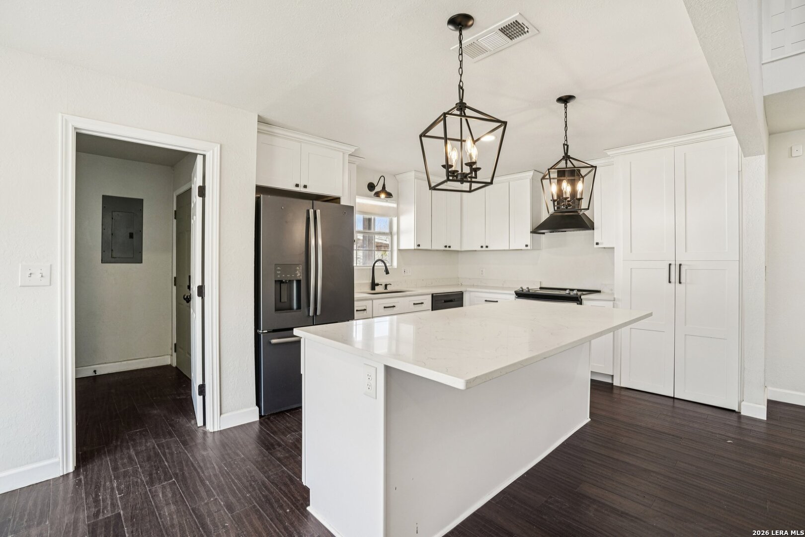706 Quail Run Lytle, TX 78052 - Photo 20 of 51 a kitchen with kitchen island white cabinets and stainless steel appliances