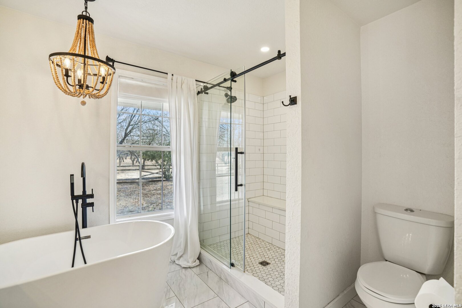 706 Quail Run Lytle, TX 78052 - Photo 24 of 51 a bathroom with a shower and a toilet