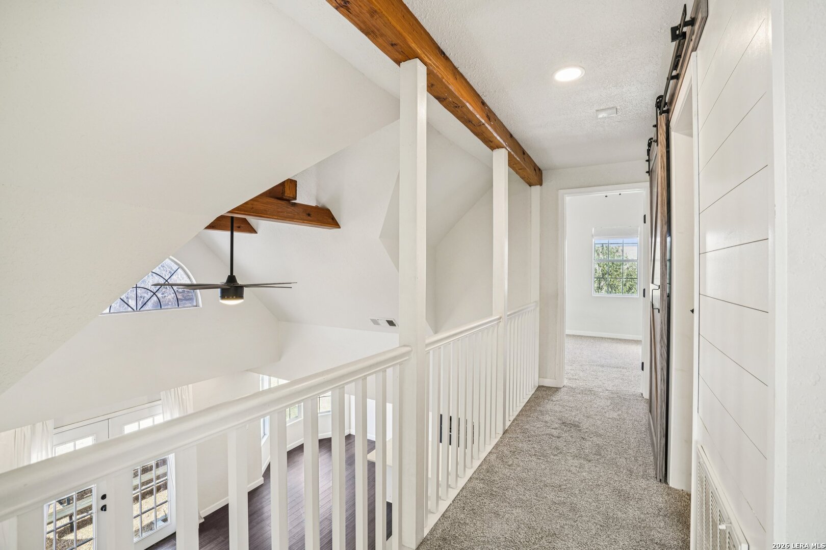 706 Quail Run Lytle, TX 78052 - Photo 33 of 51 a view of a hallway with windows and stairs