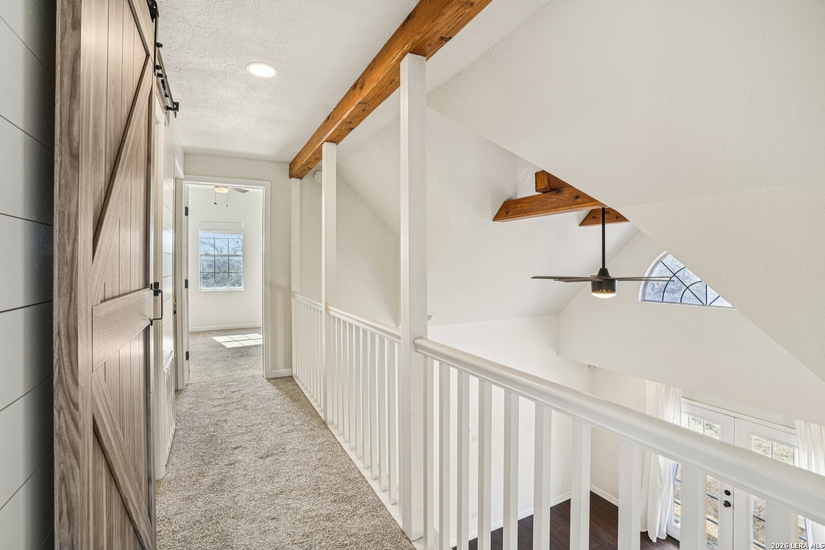 706 Quail Run Lytle, TX 78052 - Photo 39 of 51 a view of a hallway with wooden floor and staircase