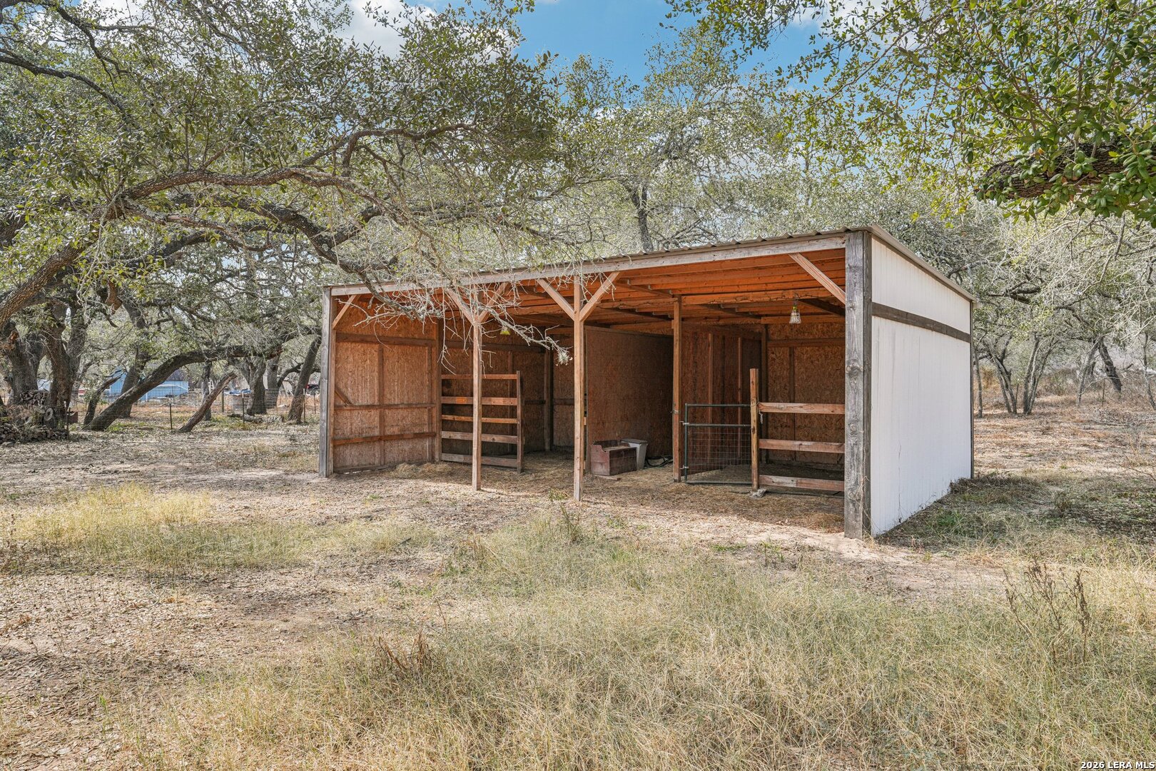 706 Quail Run Lytle, TX 78052 - Photo 47 of 51 a view of a wooden house with a large tree