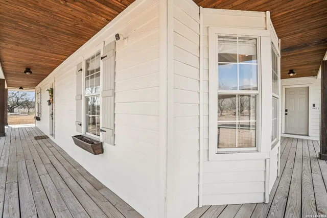 a view of balcony with wooden floor and fence