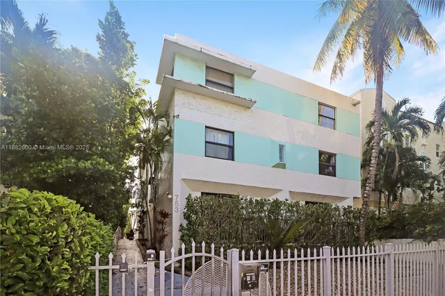 a front view of a house with a palm tree
