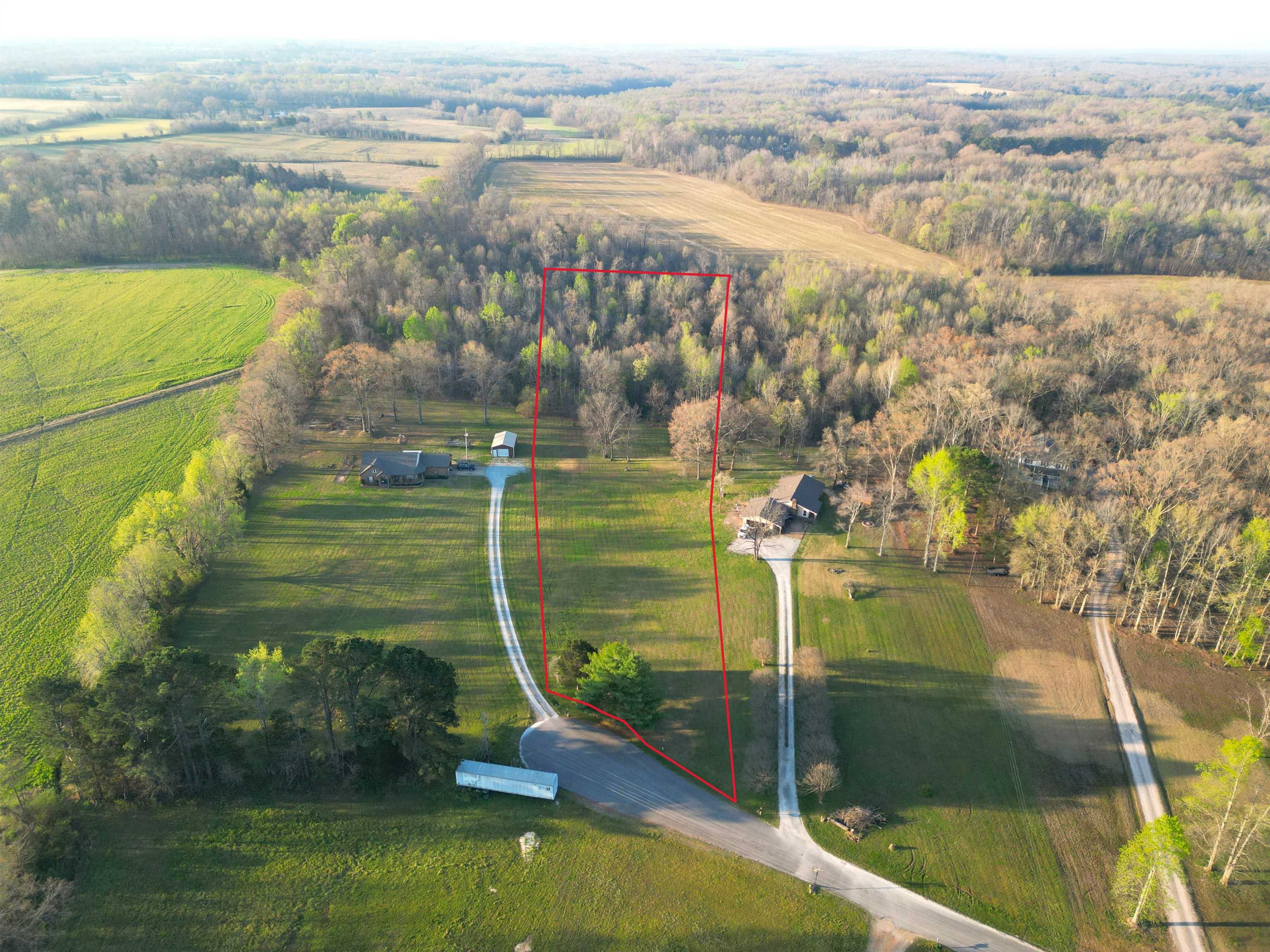 Aerial view of sparsely populated area featuring property boundaries highlighted