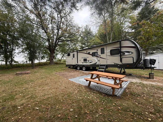 a backyard of a house with barbeque oven table and chairs