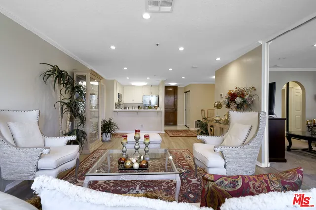 a living room with furniture and a chandelier