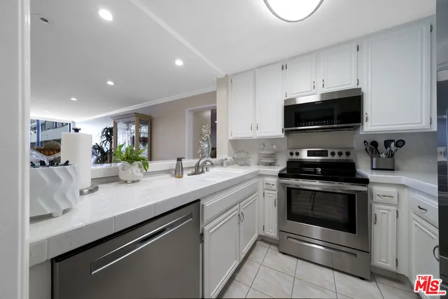 a kitchen with a sink stove and microwave