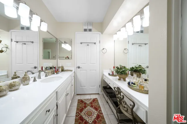 a bathroom with a double vanity sink mirror and toilet
