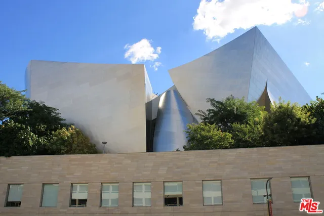 a front view of a house with a yard and potted plants