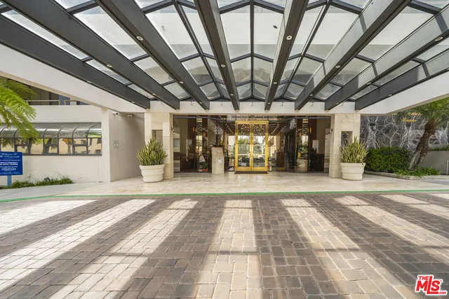 a view of a porch with furniture and a parking space
