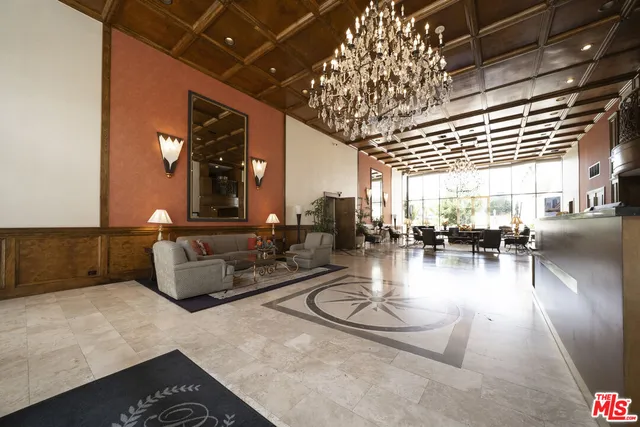 a living room with lots of furniture and a chandelier