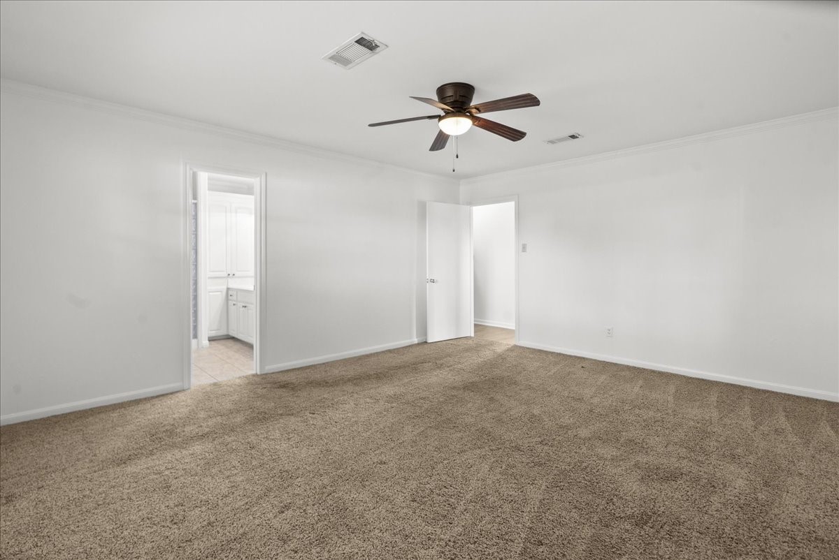 105 Alice Street Anahuac, TX 77514 - Photo 14 of 36 a view of an empty room with a ceiling fan