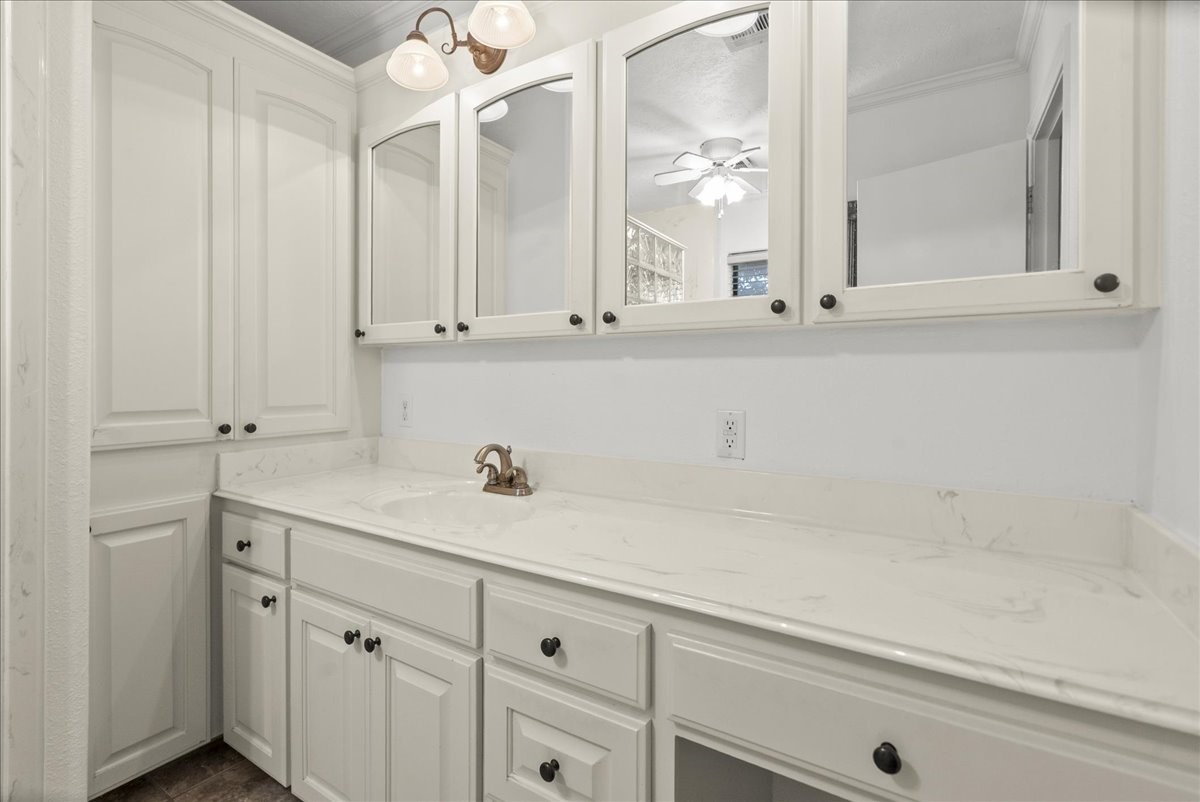 105 Alice Street Anahuac, TX 77514 - Photo 15 of 36 a bathroom with a sink and a mirror